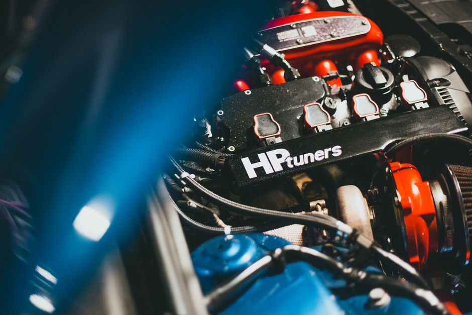 Dynamic close-up of a modern car engine featuring HP Tuners branding, showcasing automotive technology.